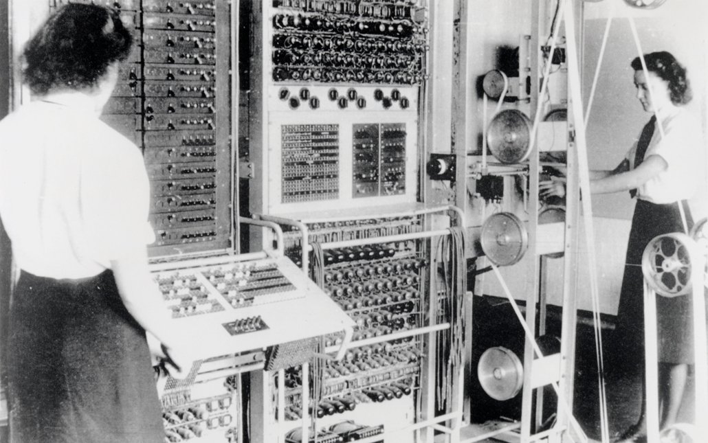black and white image of two women operating Colossus at Bletchley Park
