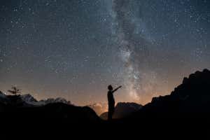 HDKGGA Milky Way. Night sky with stars and silhouette of a man